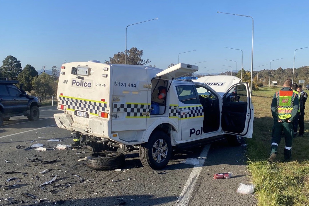 Police car struck while attending to collision