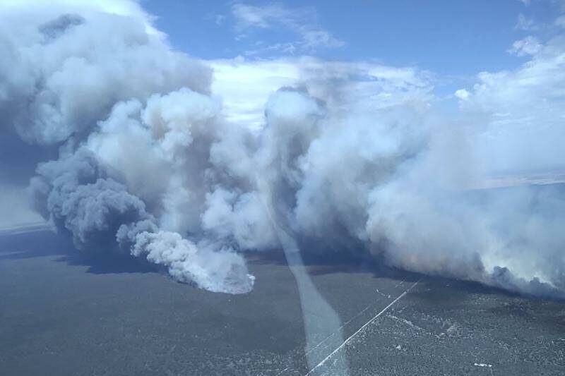 Risk eases for bushfire but another may burn for weeks