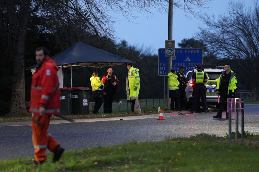 Police return to shooting scene as slain officers named