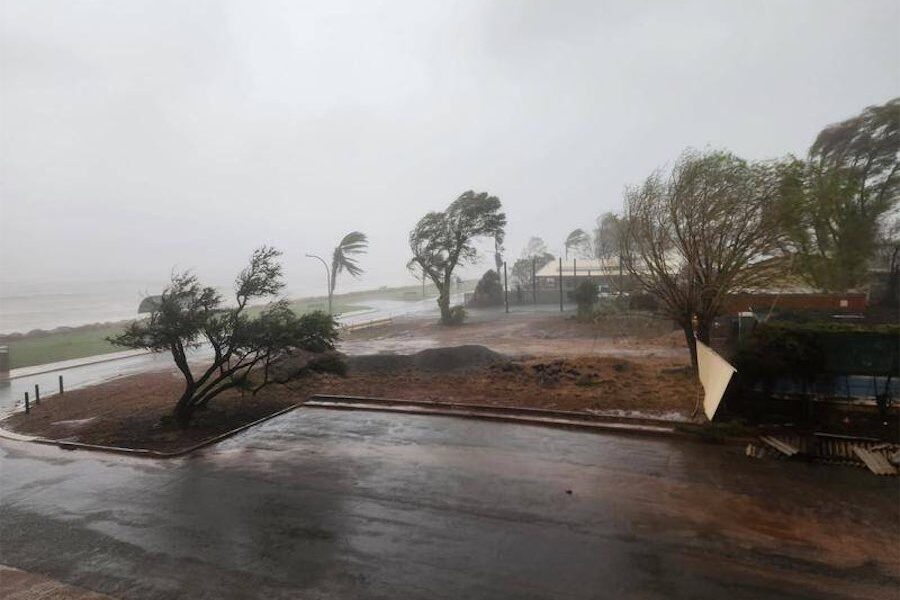 ‘Too late to leave’: cyclone weakens but hazards remain